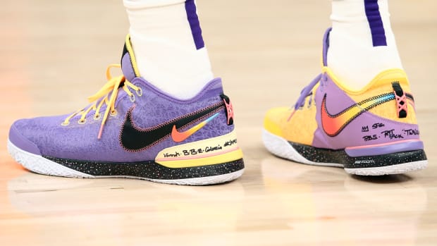 View of LeBron James' purple and gold Nike shoes.